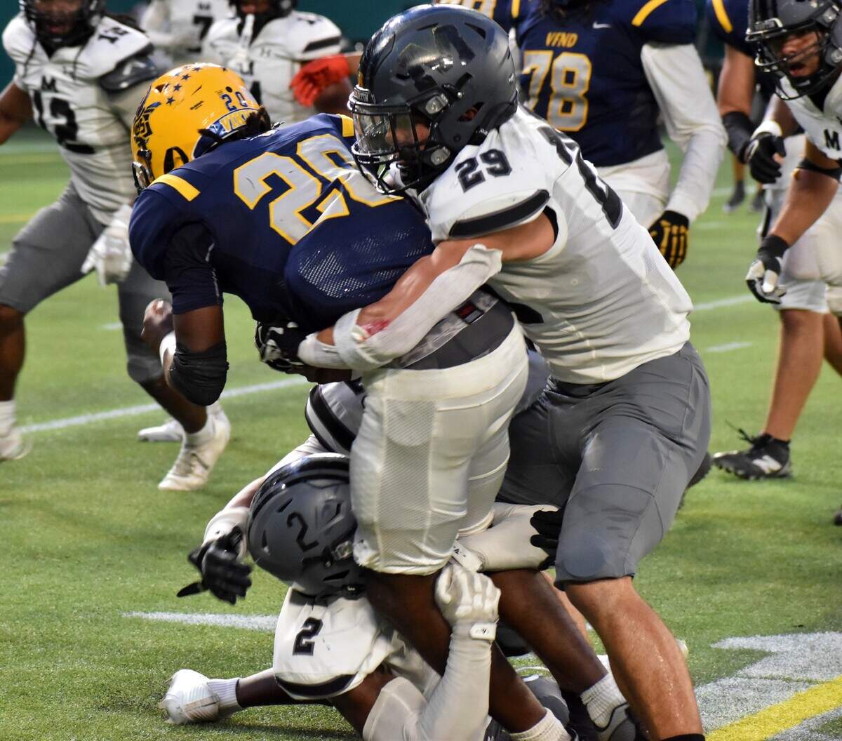 Arlington Martin’s Kevin Grant (2) and Julian DeLeon (29) combine to tackle Arlington Lamar running back Tayrone Thomas in the first quarter of a UIL football Class 6A game at Choctaw Stadium in Arlington on Thursday, Sept. 18, 2025.