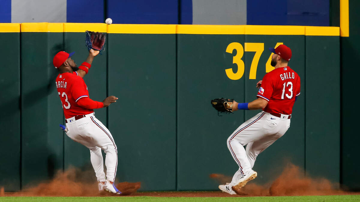 Texas Rangers right fielder Joey Gallo (right) looks on as center fielder Adolis Garcia (left) catches a fly out hit during the fifth inning Friday, June 25, 2021, in Arlington, Texas.