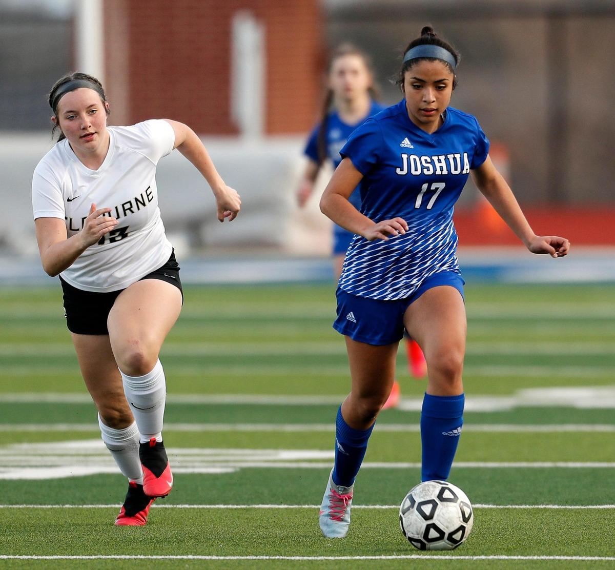 Joshua’s Karen Miranda (17) drives the ball chased by Cleburne’s Emma Rohr (13) during a District 14-5A high school soccer game at Joshua High School in Joshua, Texas, Monday, March 08, 2021. The girls played to a scoreless game. (Special to the Star-Telegram Bob Booth)
