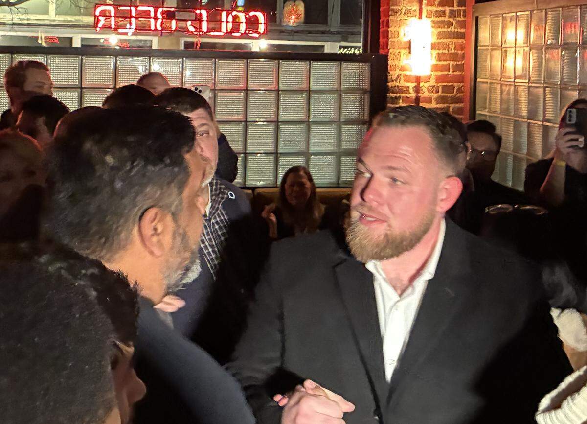 Taylor Rehmet greets a supporter at his Senate District 9 runoff watch party at Nickel City in Fort Worth on Saturday, Jan. 31, 2026.