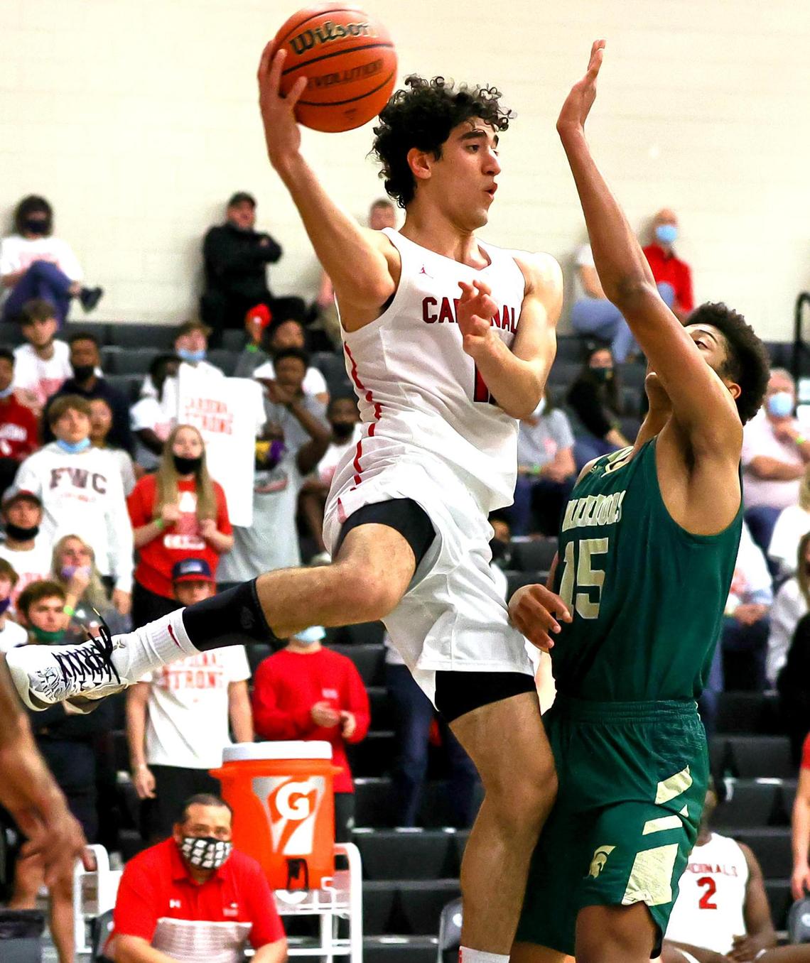 Fort Worth Christian forward Alexander Zambie (11) looks to make a pass against The Woodlands Christian Academy forward Chanse Perkins (15) during the second half of the 5A TAPPS Boys Basketball State Championship game played on March 12, 2021 at College Station High School in College Station, TX. (Steve Nurenberg Special to the Star-Telegram)