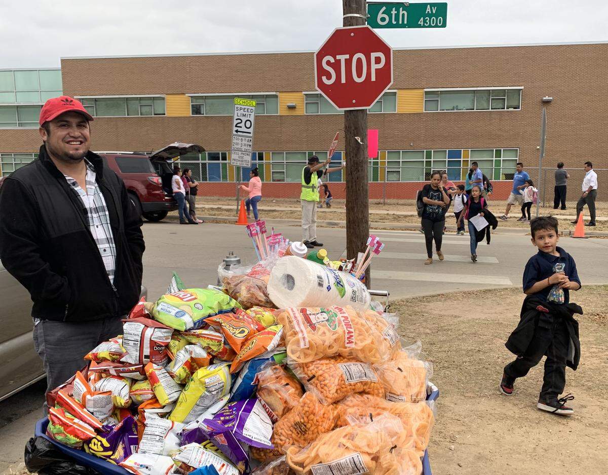 A food vendor offers snacks to parents and children leaving Rosemont Elementary School in south Fort Worth.