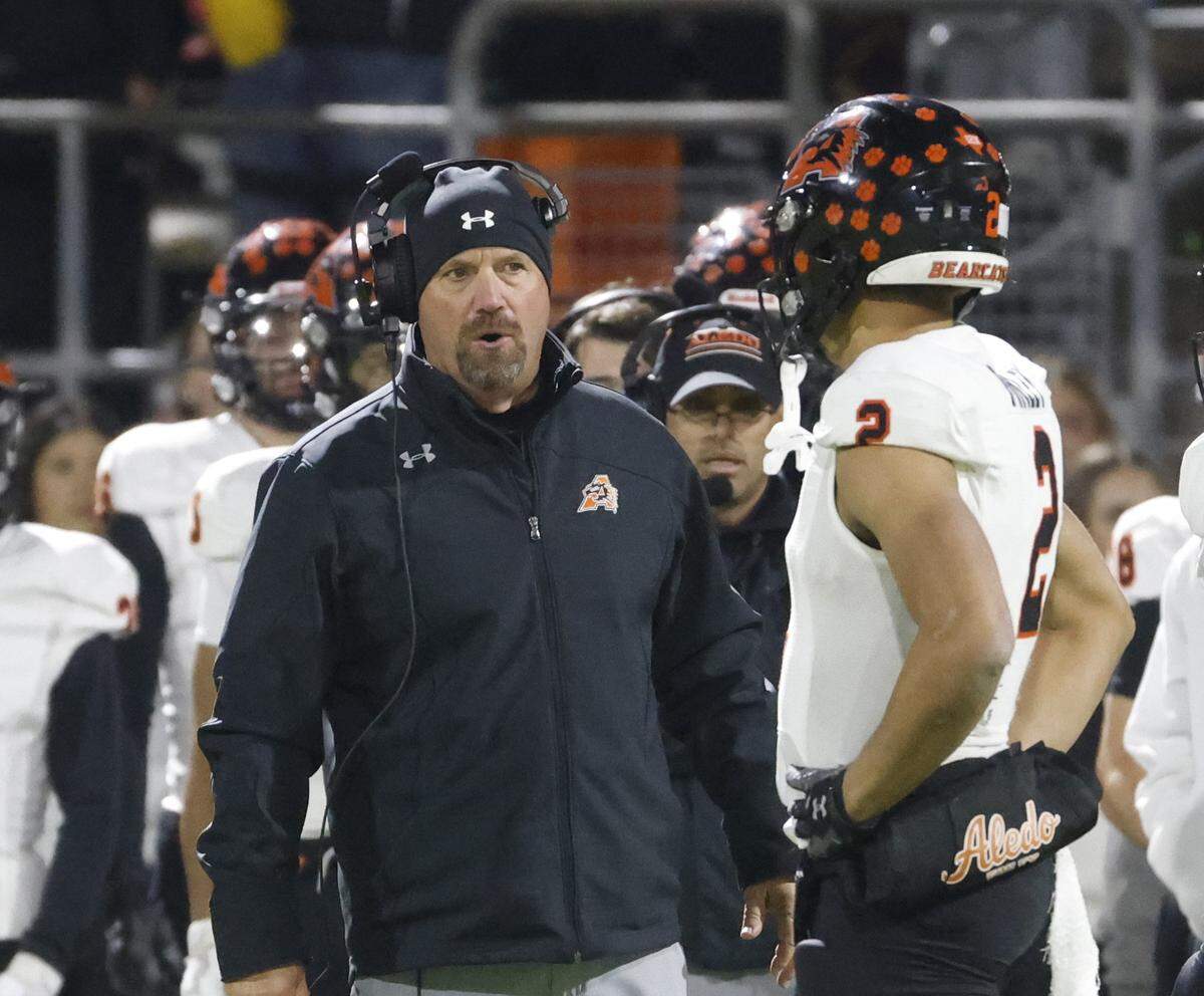 Aledo head coach Robby Jones talks to wide receiver Kaydon Finley (2) on the sidelines during the first half of a UIL Class 5A Division I Quarterfinal on Friday Dec. 05, 2025 at Northwest ISD Stadium in Fort Worth, Texas.
