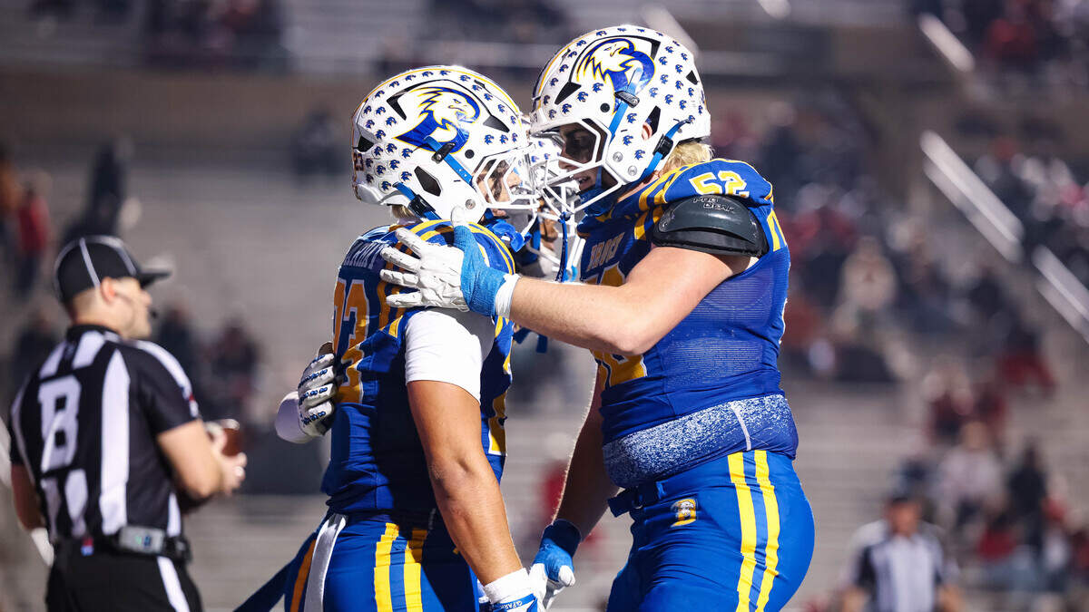 Brock running back Jack Farhat celebrates with his teammate in the end zone after scoring a touchdown in a Class 4A Division II state semifinal against Carthage on Friday at Memorial Stadium in Mesquite.