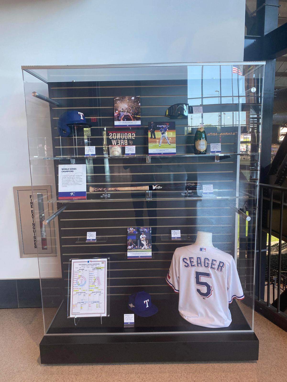 A display case with objects from the 2023 World Series.