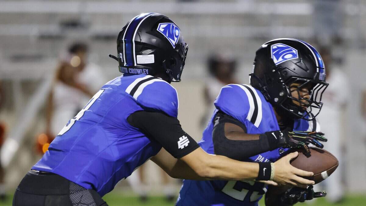 North Crowley quarterback Hayes Cloutier (9) hands off to  running back Kiante Ingram (23) during the first half of a UIL football game at Crowley ISD Stadium in Crowley, Texas, Thursday August, 28, 2025.
