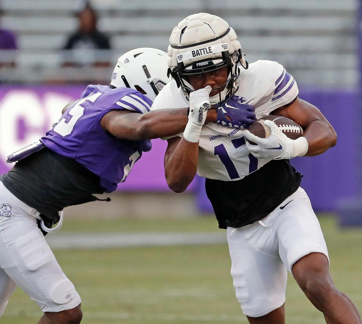 TCU safety Jamel Johnson (25) reaches in to contain running back Trent Battle (17) during the TCU Spring Game at Amon G. Carter Stadium in Fort Worth, Texas, Friday, Apr. 14, 2023. (Special to the Star-Telegram Bob Booth)