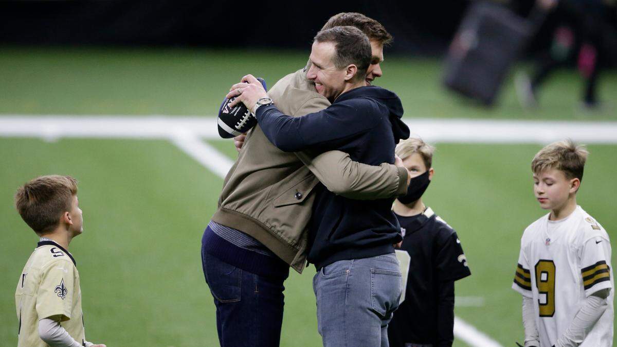 New Orleans Saints quarterback Drew Brees right, embraces Tampa Bay Buccaneers quarterback Tom Brady as Bree’s three boys look on after the Saints were eliminated in a Divisional Round playoff game at the SuperDome on Jan. 17. Brees’ boys and daughter announced via video on social media that the former Austin Westlake star was retiring after a Hall of Fame, 20-year NFL career.