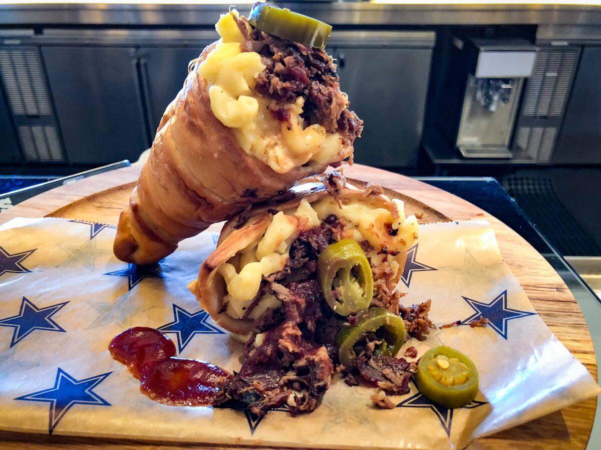 Mac N Cheese Brisket Cone,  A bread cone filled with Cowboys mac n cheese and topped with brisket.