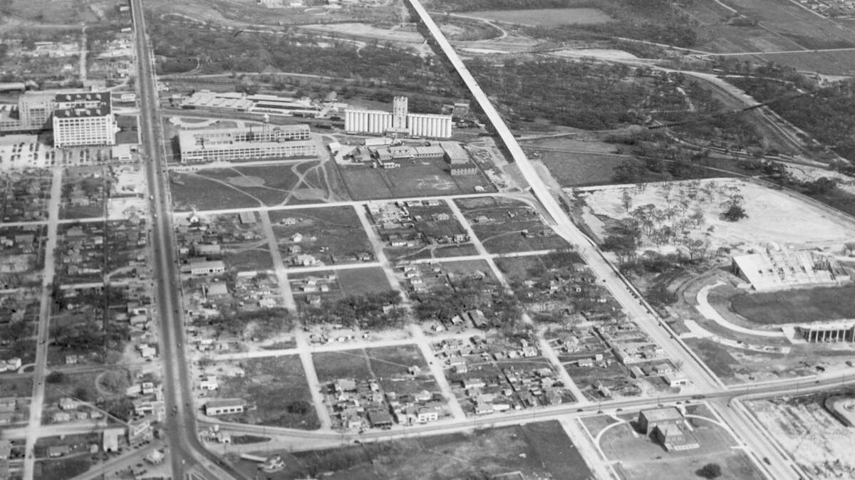 A March 1939 view of construction of the West Lancaster Avenue Bridge in Fort Worth, looking east. Farrington Field is along the right edge of the photo, and Montgomery Ward/Montgomery Plaza at the upper left.