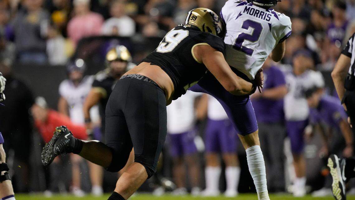 Colorado defensive lineman Jalen Sami, left, hits TCU quarterback Chandler Morris during their game on Friday. Morris sustained a knee injury in the game.