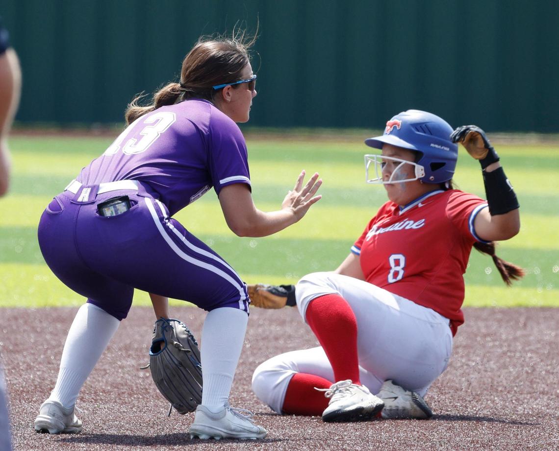 Grapevine catcher Ashley Johnson (8) slides into second safely under the defense of Hallsville second baseman Ava Martin (13) during game 2 of the UIL softball semifinal 5A D2 playoffs at The Rabbit Hole in Forney, Texas, Saturday, May 24, 2025.