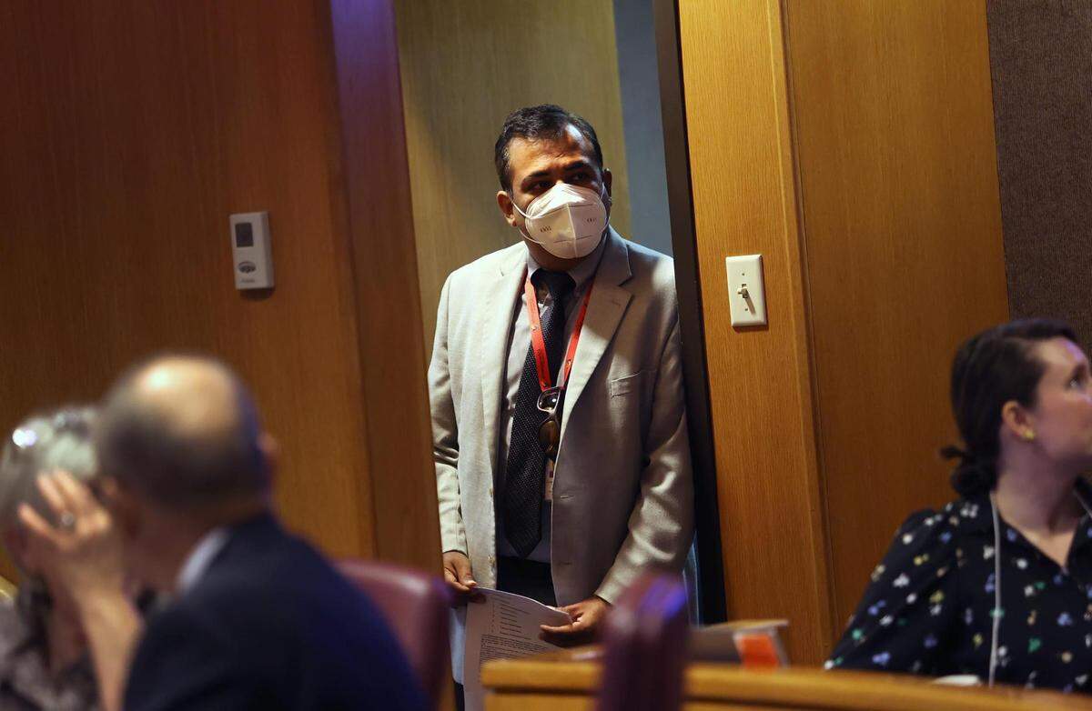 Vinny Taneja, director of the Tarrant County Health Department, looks in on a Tarrant County Commissioners Court meeting in September 2022. Taneja said the county’s COVID vaccine rollout required numerous partners, because of the magnitude of the task.