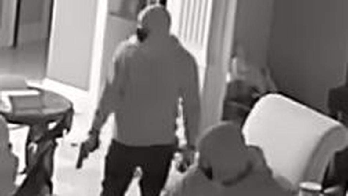Two masked intruders walk through a home in Tarrant County during a home invasion robbery in October. They zip-tied members of a family before the son and the father broke free and fought back, prompting them to flee, according to the Tarrant County Sheriff’s Office.