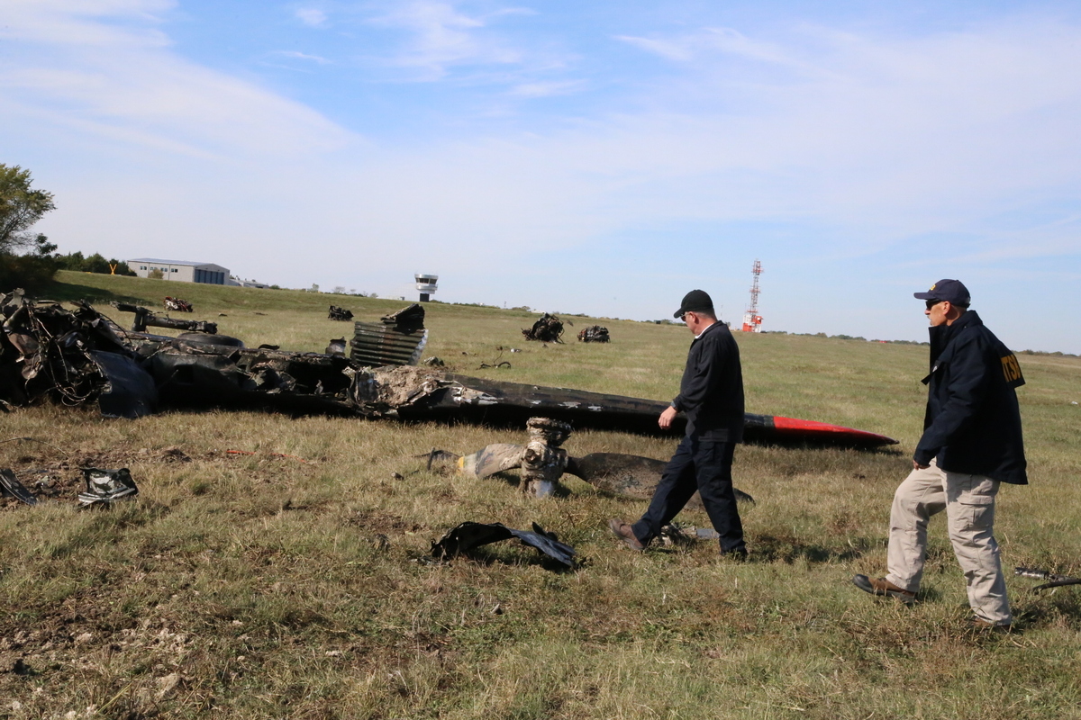 NTSB Member Michael Graham and NTSB Investigator-in-Charge Jason Aguilera walks the accident scene of the Nov. 12, 2022, mid-air collision between a Boeing B-17G and a Bell P-63F near Dallas, Texas.