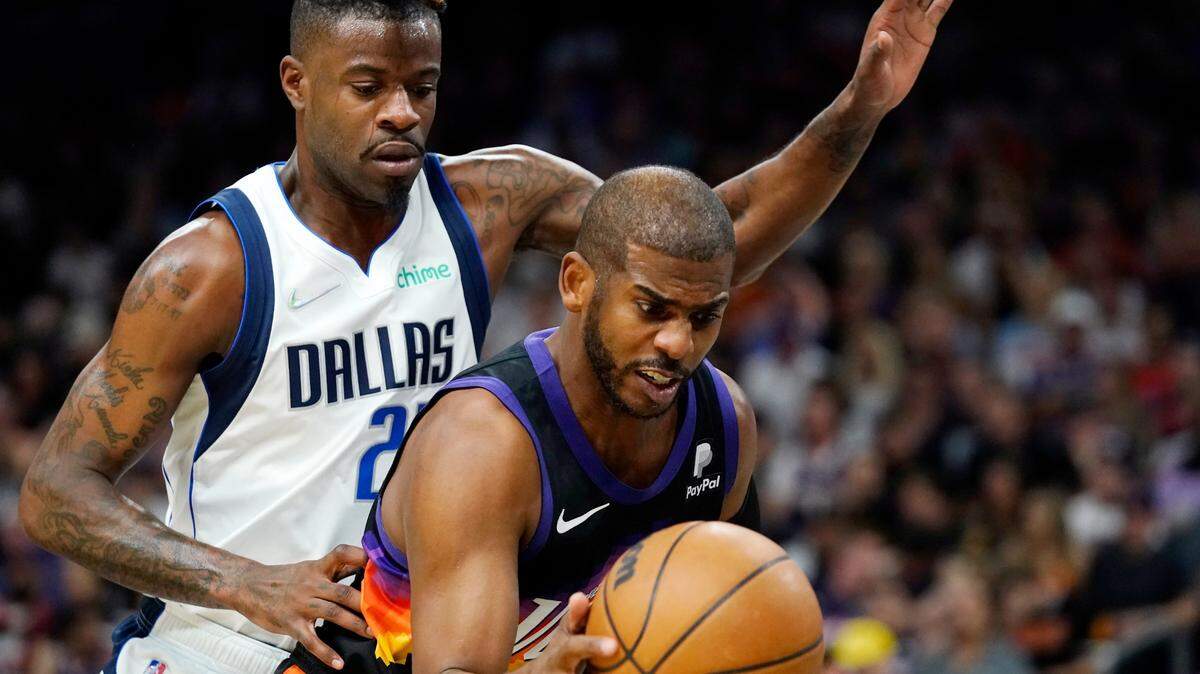 Phoenix Suns guard Chris Paul, right, grabs a rebound in front of Dallas Mavericks forward Reggie Bullock, left, during the first half of Game 5 Tuesday in Phoenix.