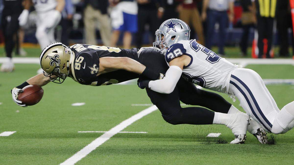 New Orleans Saints tight end Dan Arnold is tackled by Dallas Cowboys strong safety Jeff Heath in the first half Thursday night. Dallas led 13-0.