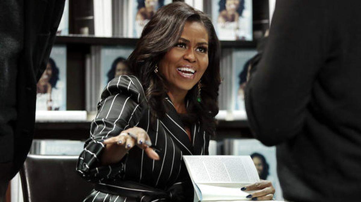 FILE - In this Nov. 30, 2018 file photo, former First Lady Michelle Obama signs books during an appearance for her book, “Becoming,” in New York. Obama’s book quickly became among the best-selling political memoirs ever. (AP Photo/Richard Drew, File)