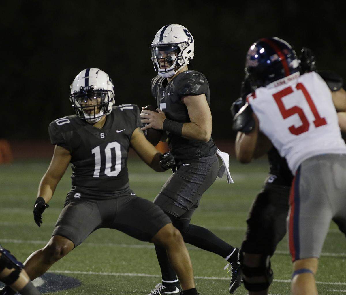 All Saints Episcopal’s Gavin Beard looks for a receiver against Grapevine Faith during their game at All Saints Episcopal on Friday, Oct. 10, 2025.