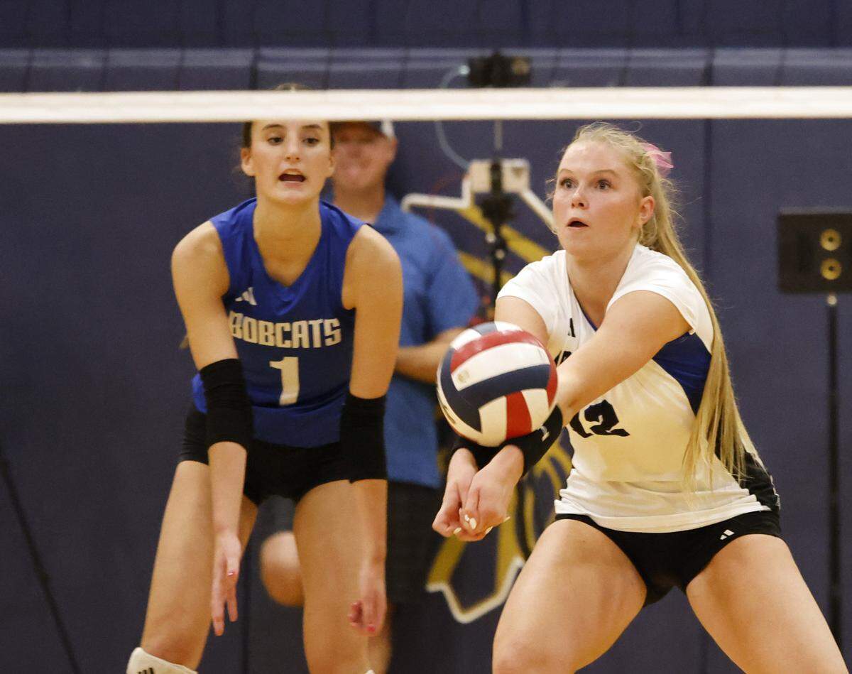 Byron Nelson senior outside hitter Ashlyn Seay (right) sets the ball next to junior libero Savannah Sterna.