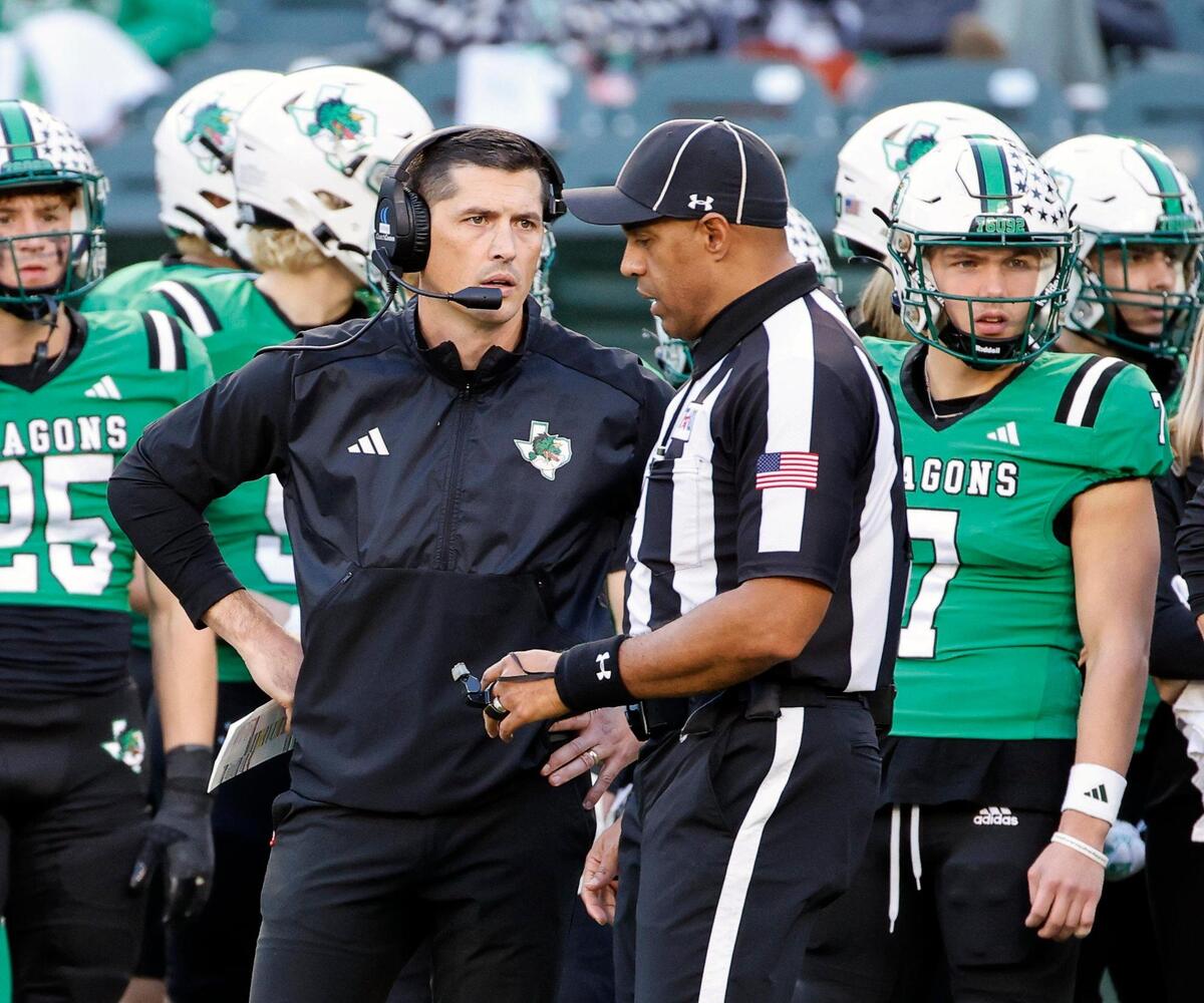 Carroll head coach Riley Dodge talks with side judge Reginald Andrews about a call in the first half of a UIL Conference 6A Division 2 region football playoff game at Choctaw Stadium in Arlington, Texas, Friday, Nov. 24, 2023.