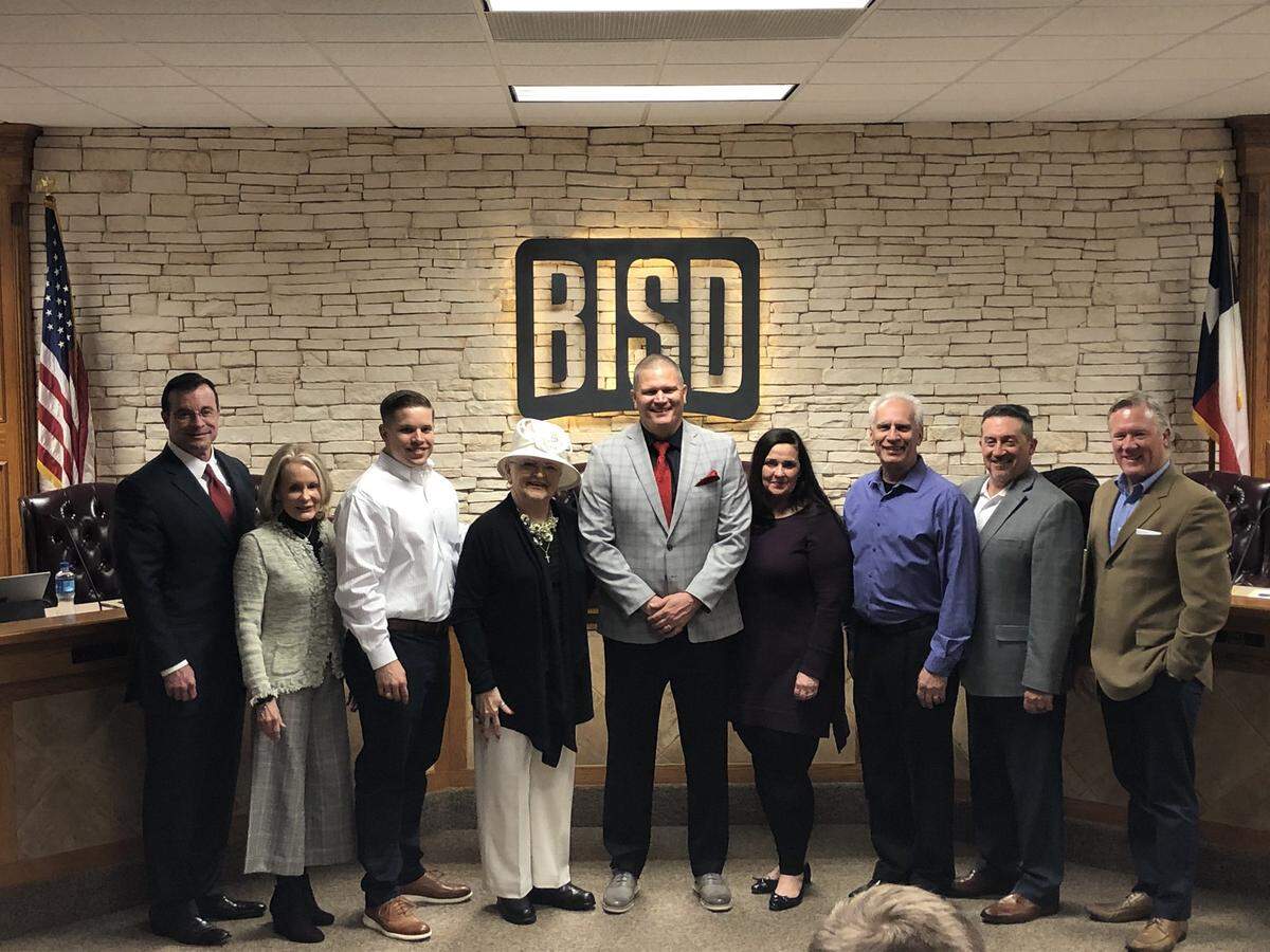 Former Dallas Cowboys QB Jon Kitna, middle, was approved as the next football coach and athletic director at Burleson High School during the Burleson ISD school board meeting, Monday March 9, 2020.
