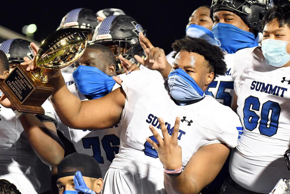 Mansfield Summit’s Kamren Washington, center, holds the trophy as he celebrates with teammates their 34-31 win over Colleyville Heritage in their Division 1-5A Regional Round Play-off football game Saturday, December 26, 2020 at Bearcat Stadium in Aledo, Texas. Special/Bob Haynes