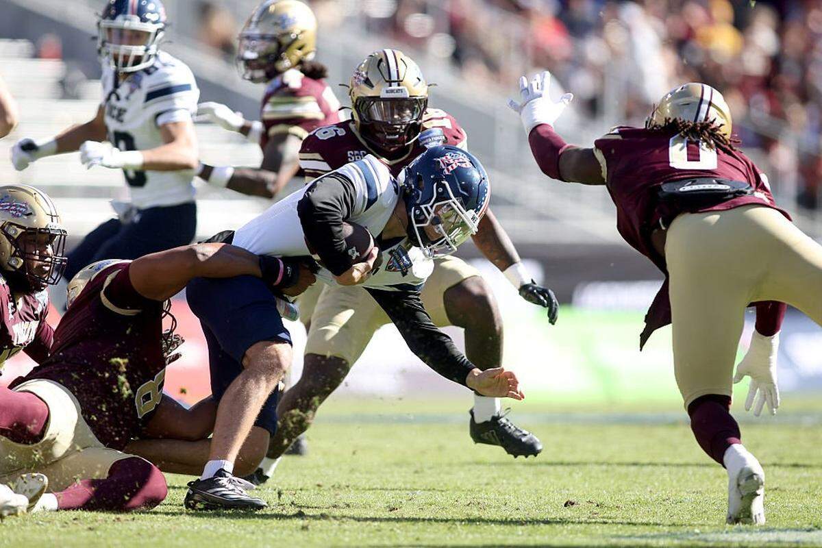 FORT WORTH, TEXAS - JANUARY 02: Lucas Scheerhorn #8 of the Rice Owls is tackled by Kamren Washington #8 of the Texas State Bobcats during the first half of the 2026 Lockheed Martin Armed Forces Bowl at Amon G. Carter Stadium on January 02, 2026 in Fort Worth, Texas. (Photo by Tim Heitman/Getty Images)