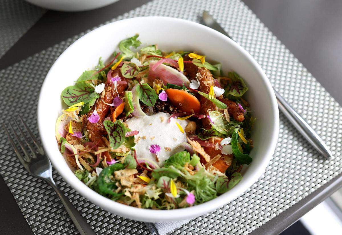 The crispy grain bowl at Café Modern is a vegan option that features roasted heirloom carrots, sugar snap peas, freekeh, red quinoa, Beluga lentils and cashew cream with a house-made blackberry ginger kombucha vinaigrette.