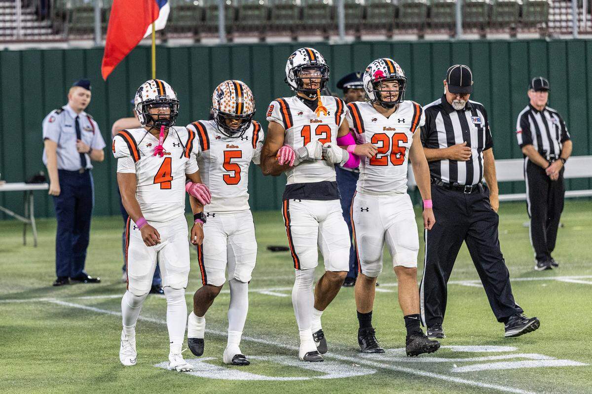 The Haltom captains walk to the coin toss before the game against Arlington Bowie on Thursday, Oct. 23, 2025, at Choctaw Stadium in Arlington.