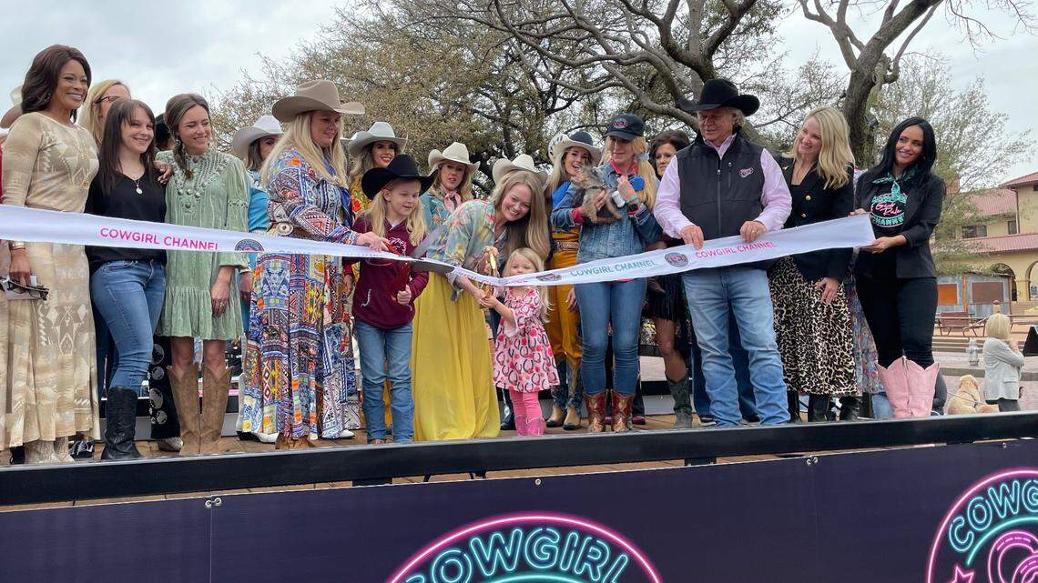 Team members behind the Cowgirl Channel get ready for a ribbon cutting to ring in the network’s official launch on Dish Network channel 269.