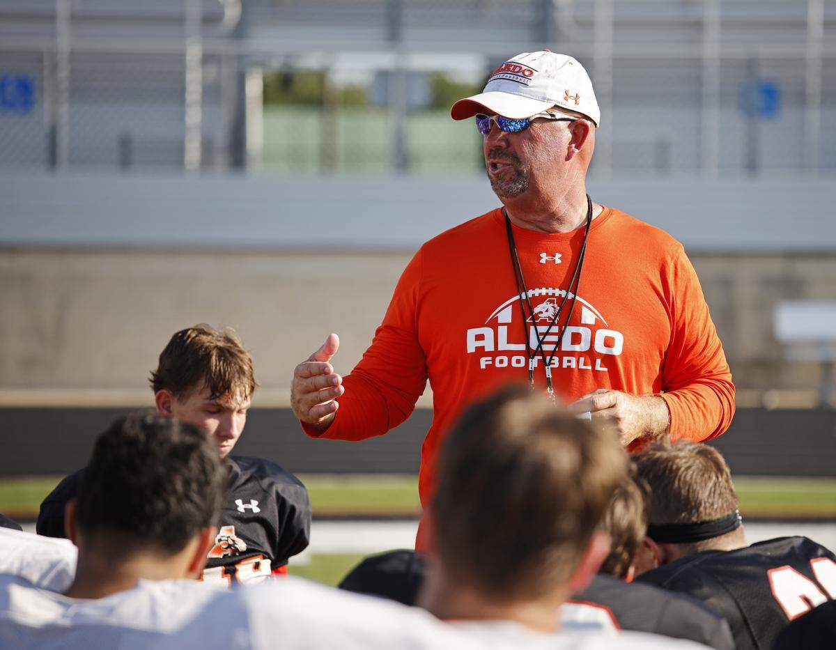 Head coach Robby Jones talks to the team after Aledo High School's morning practice at Tim Buchanan Stadium in Aledo, Texas, Monday August, 18, 2025.