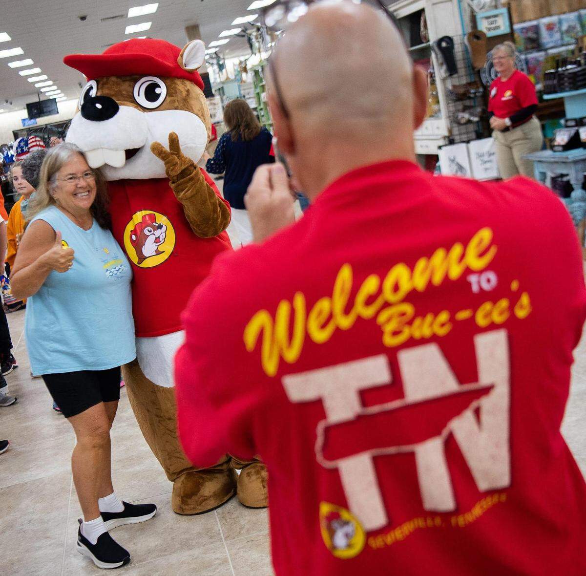 Customers take photos with the Buc-ee’s beaver mascot during the grand opening of Buc-ee’s in Sevierville, TN on Monday, June 26, 2023.