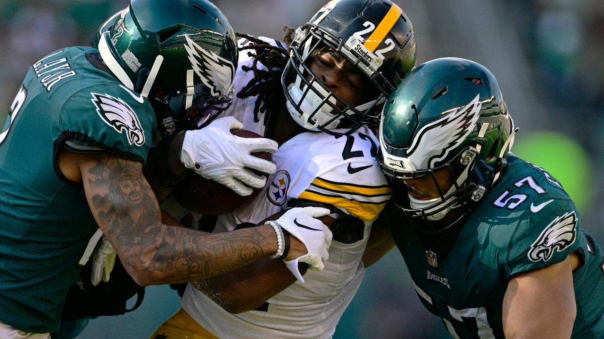 Pittsburgh Steelers running back Najee Harris (22) is stopped by Philadelphia Eagles cornerback Darius Slay (2) and linebacker T.J. Edwards during their game Sunday in Philadelphia.