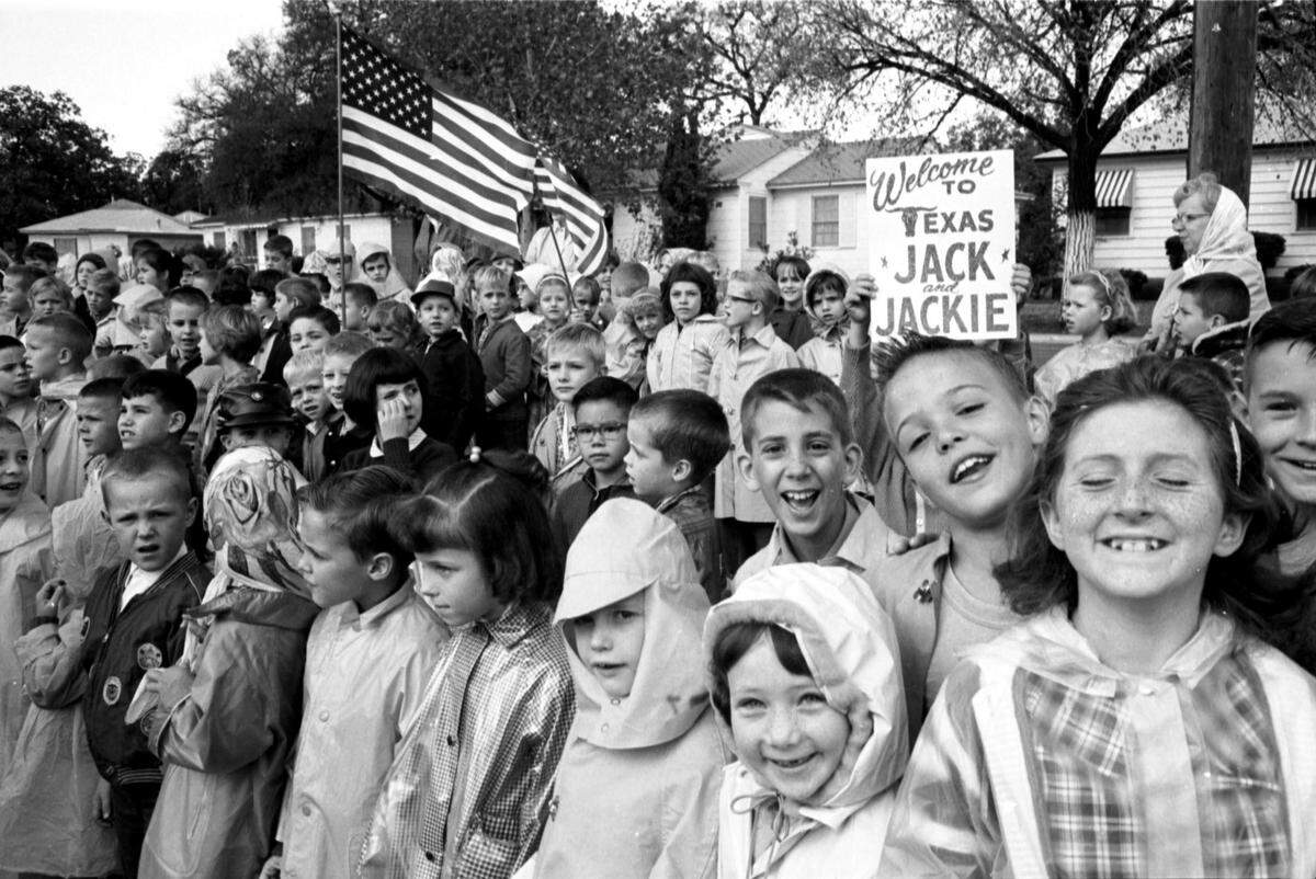Fort Worth school children wait beside the route that President John F. Kennedy’s motorcade on the way to Carswell Air Force Base on Nov. 22, 1963.