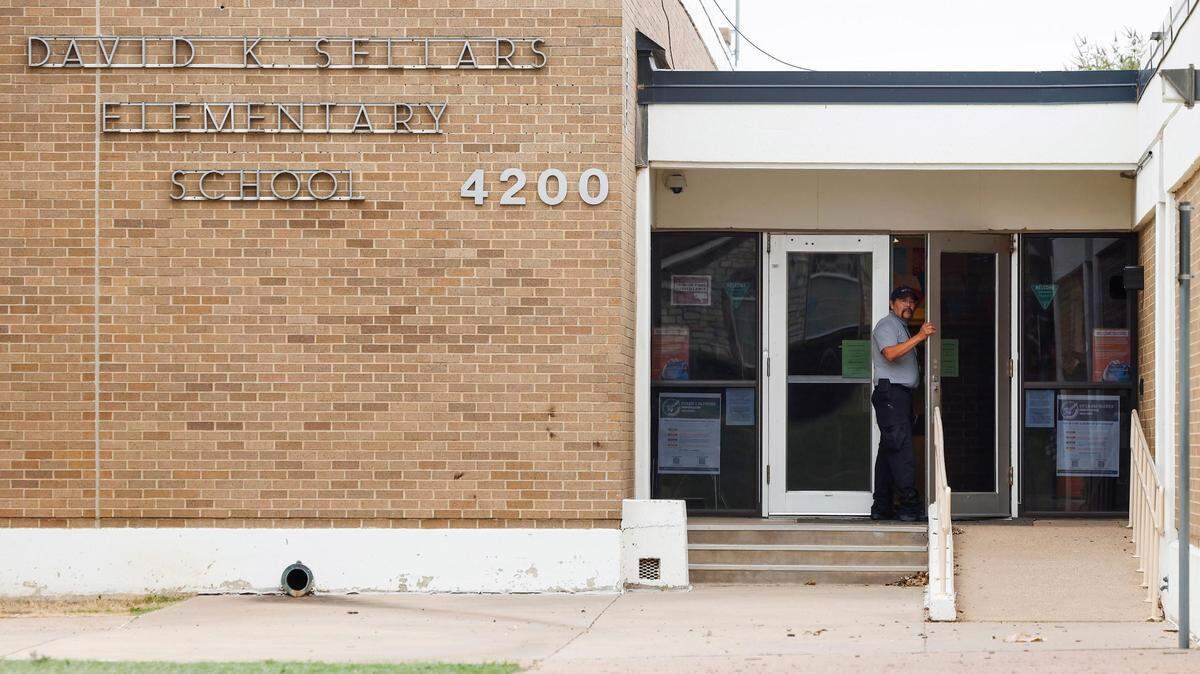 A security guard with Fort Worth ISD stands at the door of David K. Sellers Elementary School on Wednesday, October 11, 2023. A staff member was fatally shot in the back parking Wednesday morning. Forest Hill police say a person of interest in the killing was found dead Friday.
