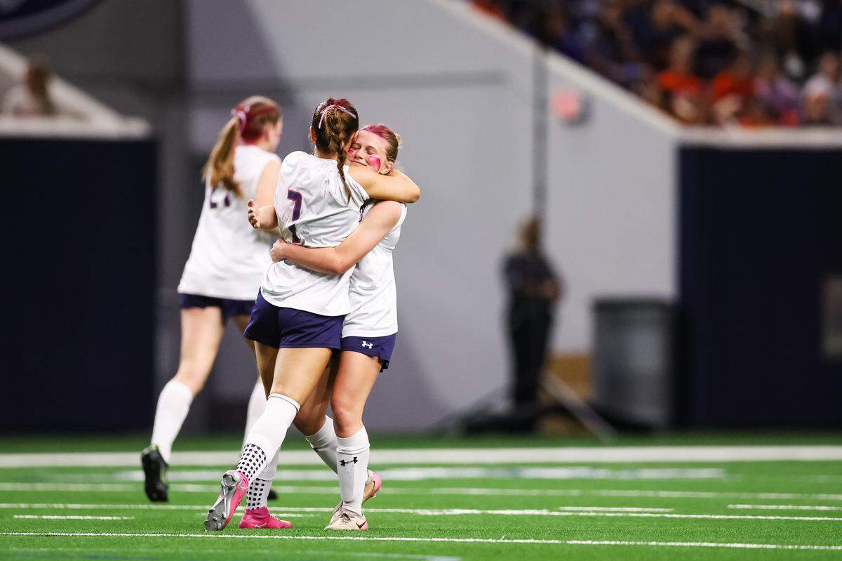 Grapevine forward Hope Harvill (7) hugs her teammate in celebration after defeating Frisco Wakeland in a Class 5A Division II UIL girls soccer state semifinal at the Ford Center on April 3, 2026 in Frisco, Texas.