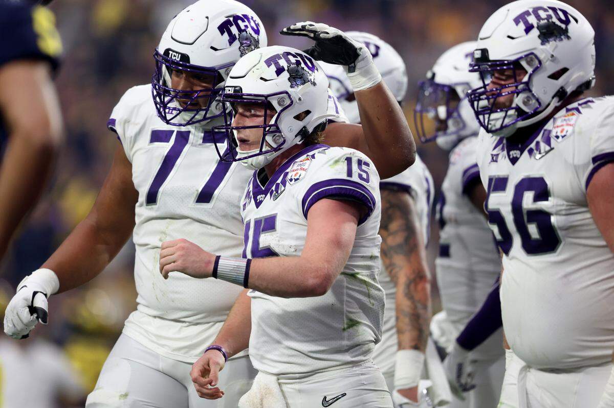 TCU offensive tackle Brandon Coleman pats TCU quarterback Max Duggan on the back after he scored a touchdown during their game against Michigan at the Vrbo Fiesta Bowl in Glendale, Ariz., on Saturday, December 31, 2022.