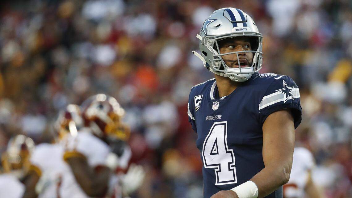 Dallas Cowboys quarterback Dak Prescott (4) looks over his shoulder during the second half of an NFL football game between the Washington Redskins and the Dallas Cowboys, Sunday, Oct. 21, 2018 in Landover, Md.