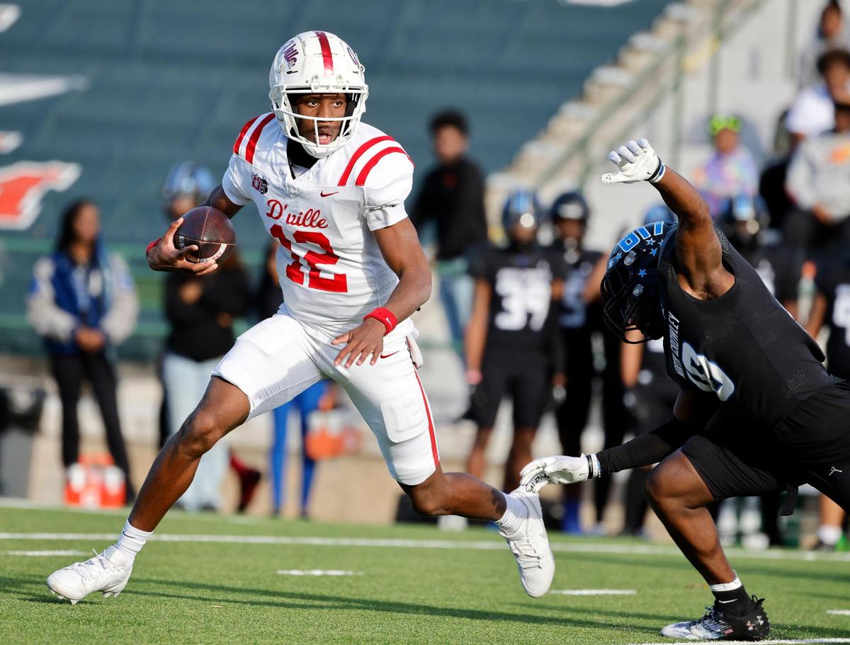 Duncanville quarterback Keelon Russell (12) scrambles away from North Crowley linebacker Braylon Turner (18) during the first half of a UIL Conference 6A Division I state semifinal football playoff game at Mesquite Memorial Stadium in Mesquite, Texas, Saturday, Dec. 09, 2023. Duncanville led North Crowley 24-0 at the half.