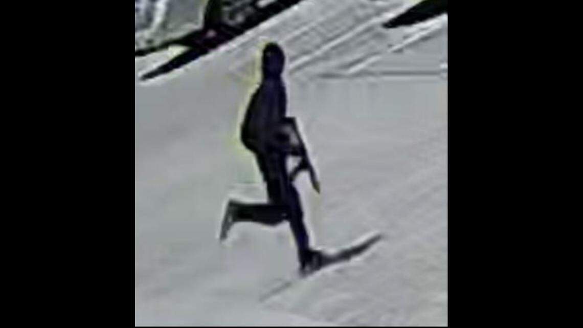 Dallas police say the man in this still from a surveillance video is suspected of walking into a Korean hair salon on March 11, shooting three women and fleeing to a maroon minivan.