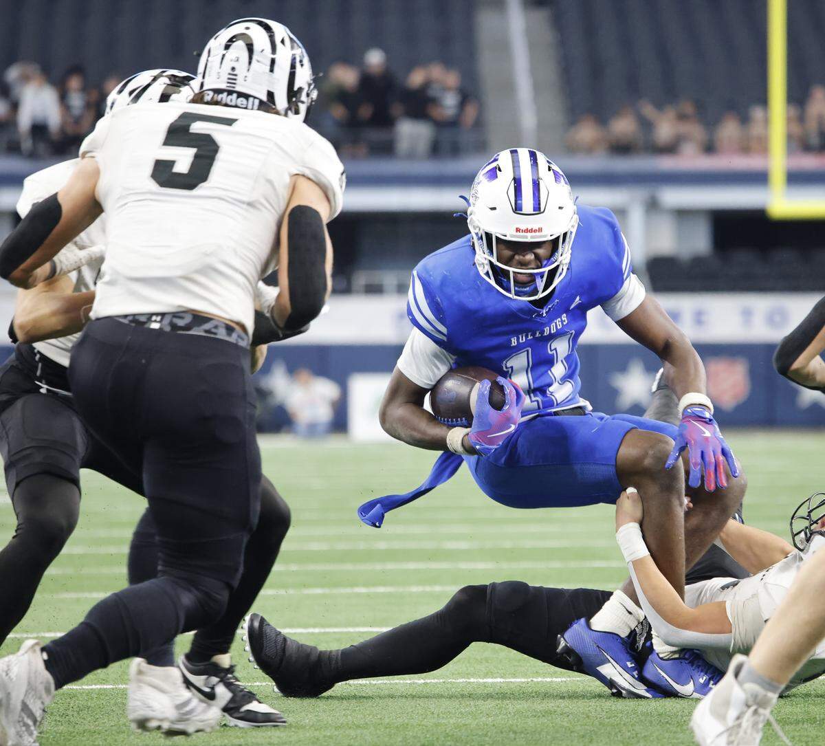Yoakum wide receiver X'Zavier Barnett (11) is dropped in the backfield by a Grandview defender during the first half of a UIL Class 3A Division I championship game on Thursday Dec. 18, 2025 at AT&T Stadium in Arlington, Texas.