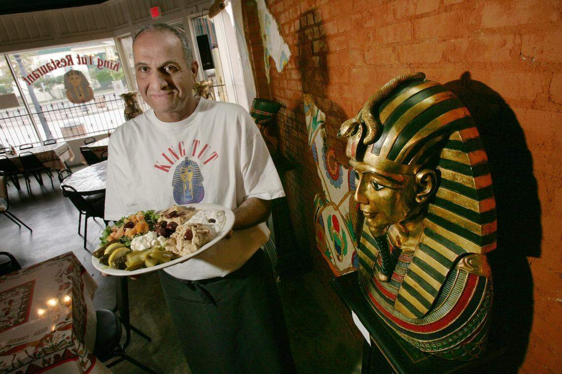 In this November 2004 file photo, King Tut Restaurant owner Amin Mahmoud holds a queen-sized sampler called a Maza plate.