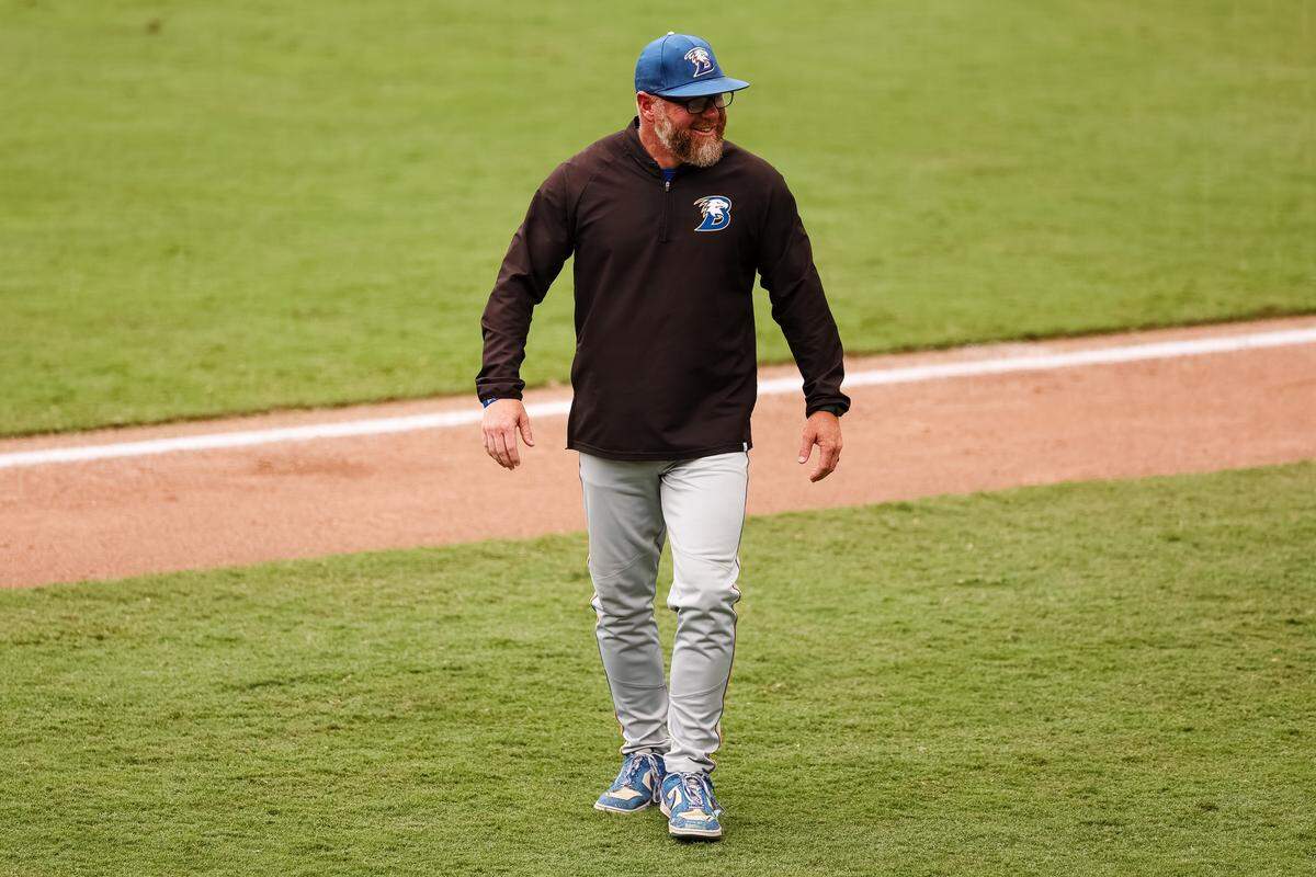 Brock head coach Koby Page smiles toward the Robinson dugout after an appeal of a play that Brock would win in the UIL Class 4A Division II baseball state championship game on Friday, June 5, 2026, at Dell Diamond in Round Rock, Texas.