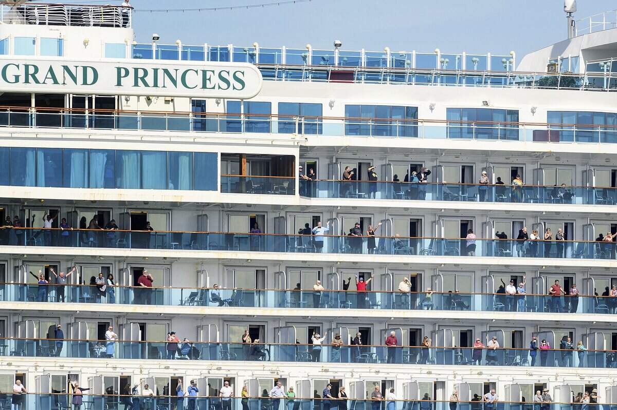 Passengers aboard the Grand Princess celebrate as they arrive in Oakland, Calif., on Monday, March 9, 2020. The cruise ship, which had maintained a holding pattern off the coast for days, is carrying multiple people who tested positive for COVID-19, a disease caused by the new coronavirus. (AP Photo/Noah Berger)