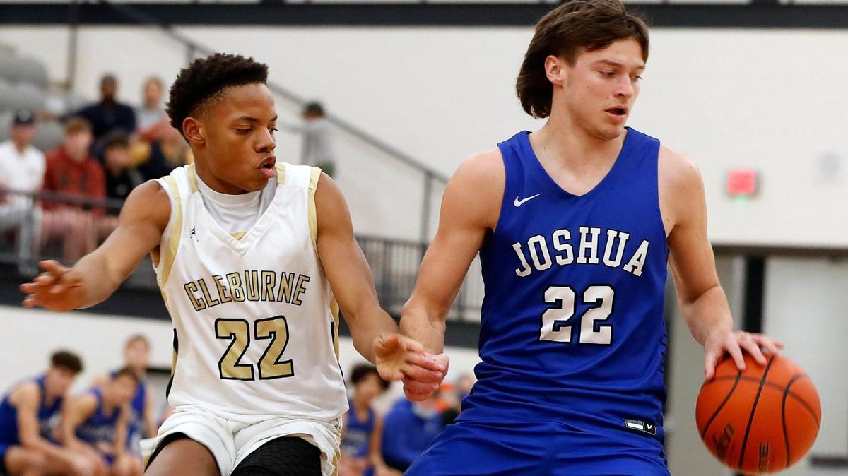 Cleburne’s Dorian Potter (22) reaches in on Joshua guard Tyler Stone (22) during the first half of a 14-5A high school basketball game at Cleburne High School in Cleburne, Texas, Tuesday, Feb. 09, 2021. Joshua led 43-28 at the half. (Special to the Star-Telegram Bob Booth)