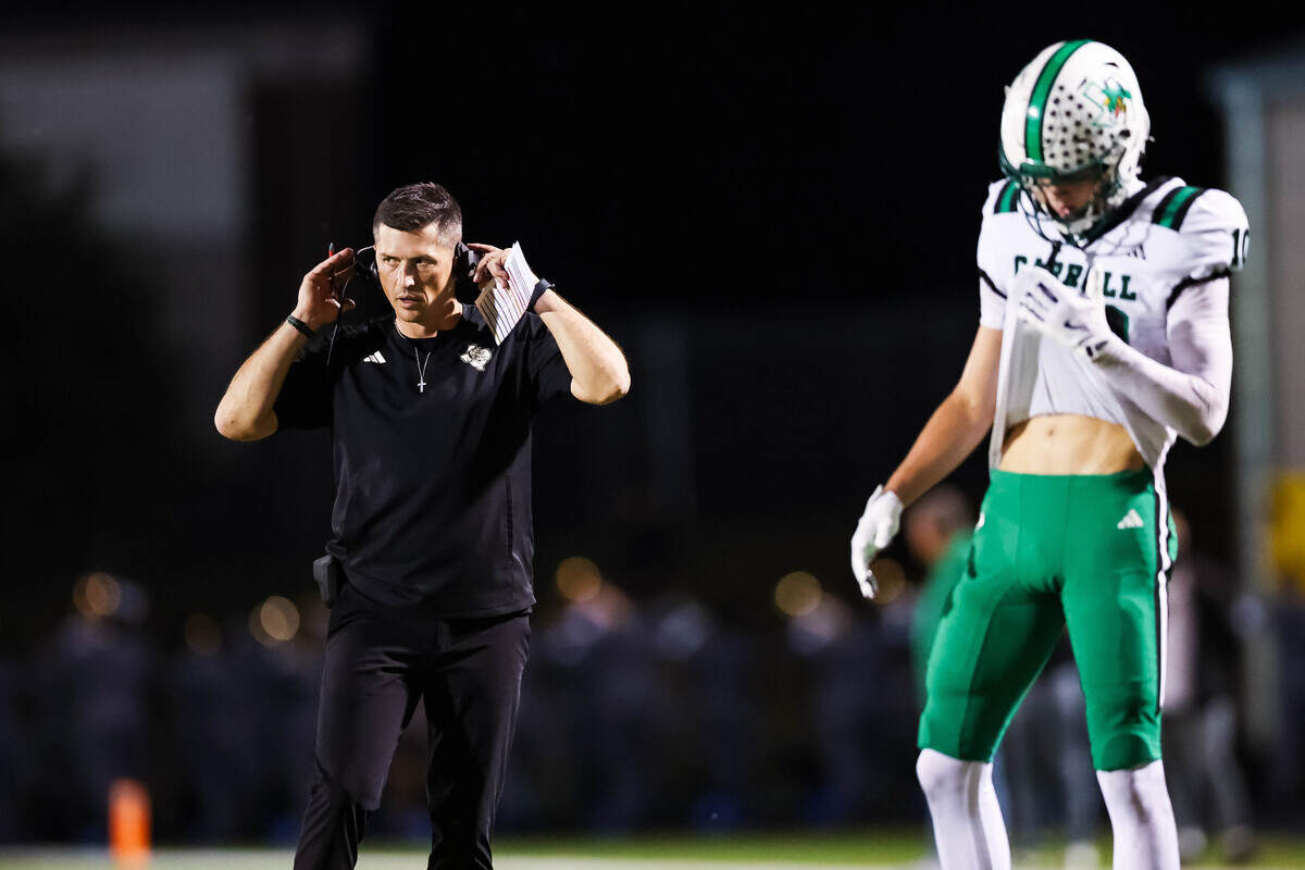 Southlake Carroll head coach Riley Dodge adjusts his headset during a timeout in a district matchup between Southlake Carroll and Timber Creek at Keller ISD Stadium on Thursday Sept. 25, 2025.