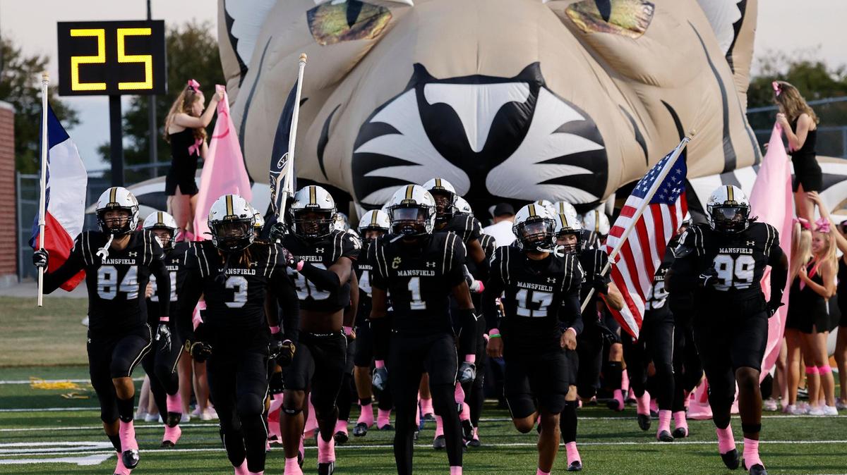 The Mansfield Tigers enter the field for the first half of a UIL high school football game at Vernon Newsom Stadium in Mansfield, Texas, Thursday, Oct. 12, 2023.
