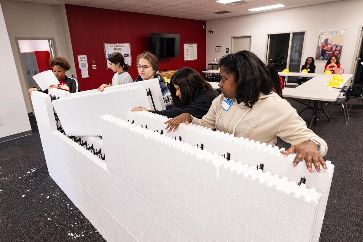 High school students work together to piece together layers of insulation foam during the ‘Women in Construction’ event by Girls Inc. of Tarrant County at their headquarters in Fort Worth on Saturday, March 8, 2025.