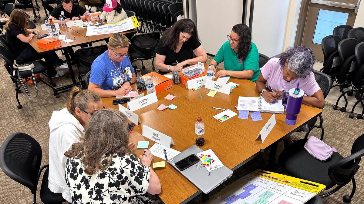 Members of the Student Safety Task Force taking part in a presentation synthesis activity at a meeting.